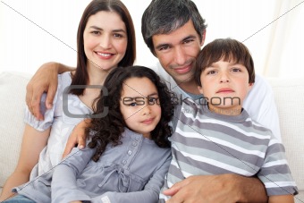Portrait of a loving family sitting on a sofa 