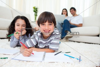 Cute children drawing lying on the floor 