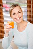 young woman holding orange-carrot juice