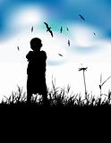 Little boy on summer field, silhouette on blue sky