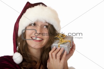 Young happy woman with Santa costume holds  Christmas gift