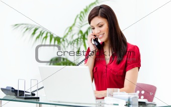 Portrait of a busy businesswoman talking on phone