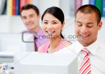 Happy business people working at a computer 