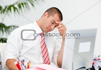 Stressed businessman working at a computer 