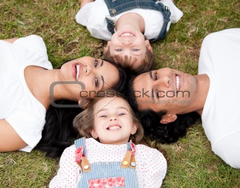 Positive family lying on the floor together