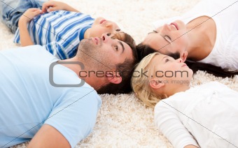 Happy family lying on the floor together