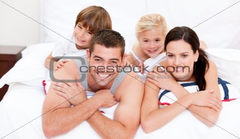 Smiling family waching television