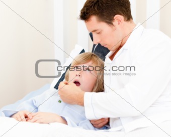 Caucasian male doctor examining a child 