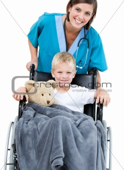 Beautiful female doctor carrying adorable little boy in the whee