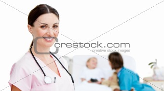 Portrait of smiling female doctor located in a patient room