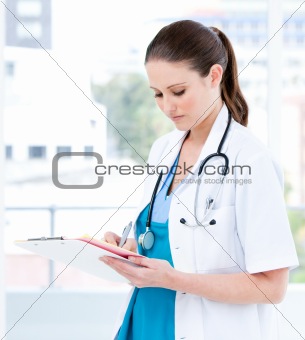 Bright female doctor writing her diagnosis