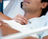 Close-up of a patient examinated by a doctor on a medical bed