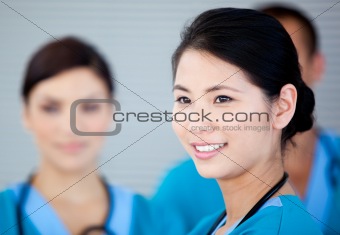 Smiling female doctor with her teamates