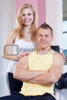 portrait of  fit young woman and man in modern gym