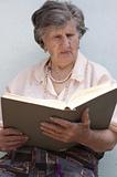 Old woman (85 years) reading book