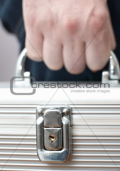 Man hand with metallic security suitcase
