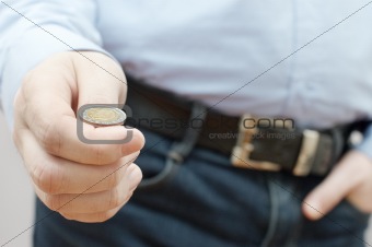 Man making choice by throwing small coin (drawing of lots)