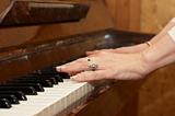 A caucasian woman's hand playing a keyboard