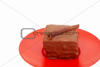 Chocolate mini-cake on red plate