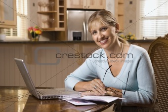 Woman paying bills on computer.