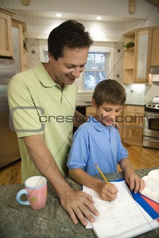 Dad helping son with homework.