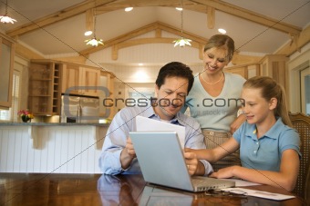 Family paying bills on computer.