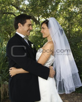 Bride and groom embracing.