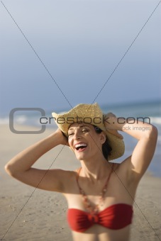 Woman in swimsuit at beach.