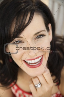 Woman smiling wearing wedding ring.