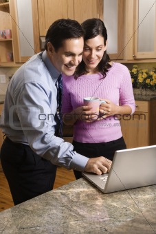 Business couple looking at laptop.