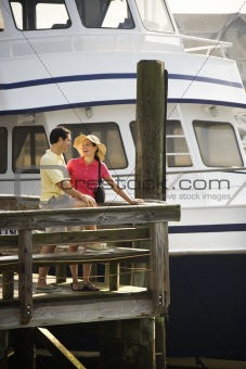 Couple at dock looking at each other.