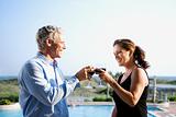 Caucasian couple toasting wine glasses.