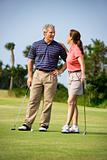 Couple talking on golf course