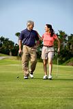 Couple walking on golf course