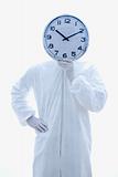 Man in biohazard suit holding clock.