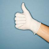 Hand wearing rubber glove giving the thumbs up signal.
