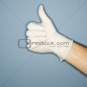 Hand wearing rubber glove giving the thumbs up signal.