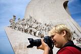 Caucasian boy with camera at the Monument to the Discoveries in 