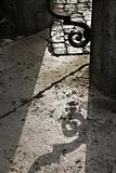 Shadow casted on ground from iron gate.