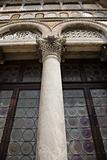Ornate column and stained glass windows in Venice, Italy.