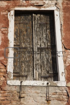 Worn building with window in Venice, Italy.
