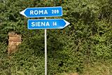 Italian street signs pointing to Rome and Siena.