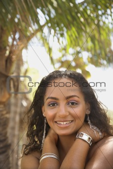Young-adult Black female smiling and making eye contact.