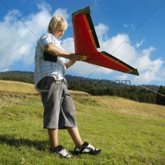 Boy preparing to fly remote controlled airplane.