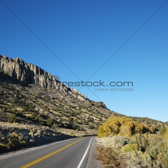 Highway cutting through montain range.