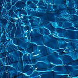 Blue reflective water with grid pattern in bottom of pool.