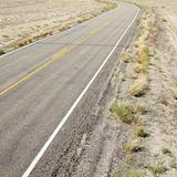 Road through barren landscape in Utah.