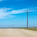 Power lines alongside dirt road in rural South Dakota.