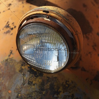 Headlight of rusty old truck.