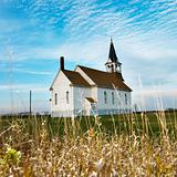 Rural church in field.